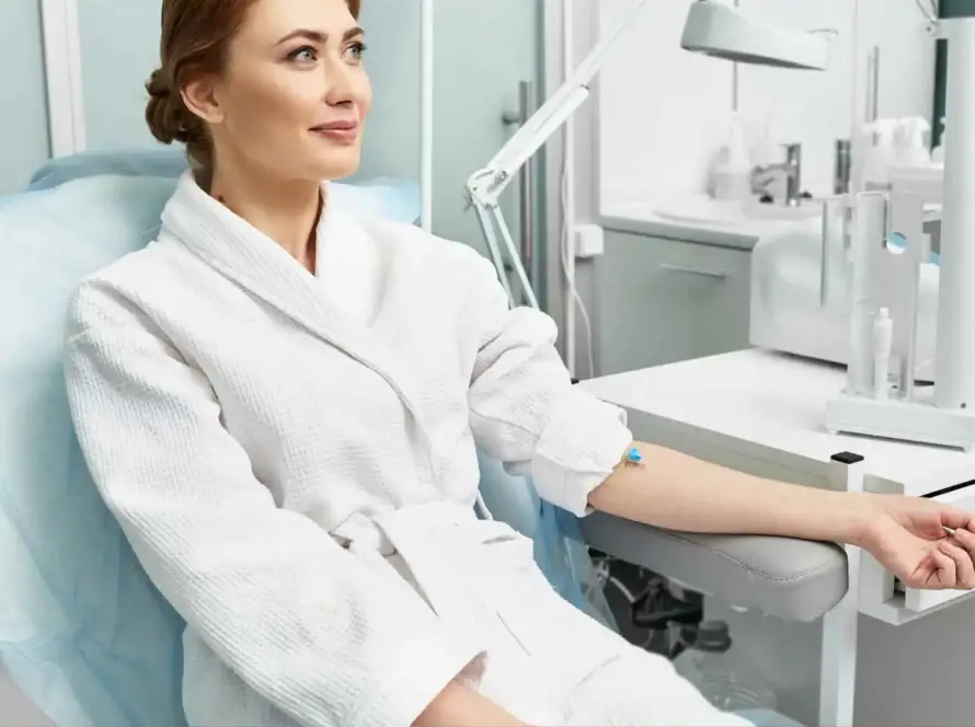 A client receiving a relaxing IV therapy nutrient drip and vitamin infusion at Xthetics Med Spa.