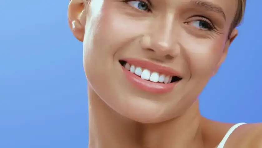 Smiling woman showing smooth skin after a Density tightening treatment at Xthetics Med Spa.