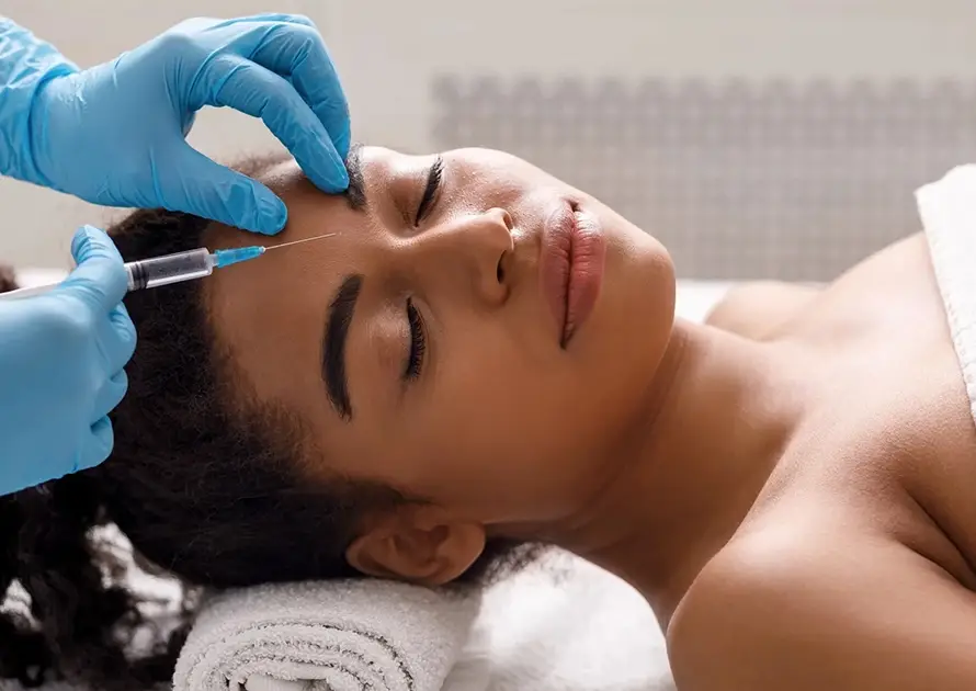 A client receiving a professional cosmetic Botox injection for forehead wrinkles at Xthetics Med Spa.