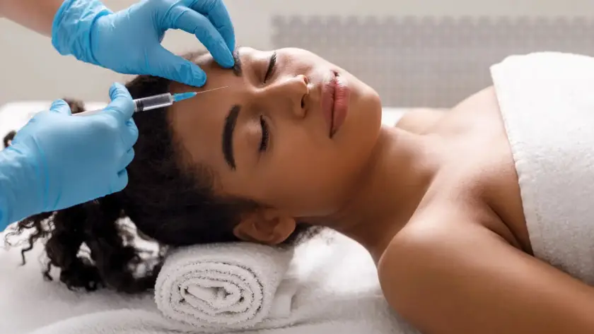 A client receiving professional cosmetic Botox injections for forehead wrinkle treatment at Xthetics Med Spa.