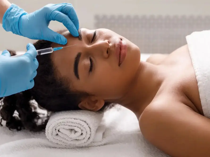 A client receiving professional cosmetic Botox injections for forehead wrinkle treatment at Xthetics Med Spa.